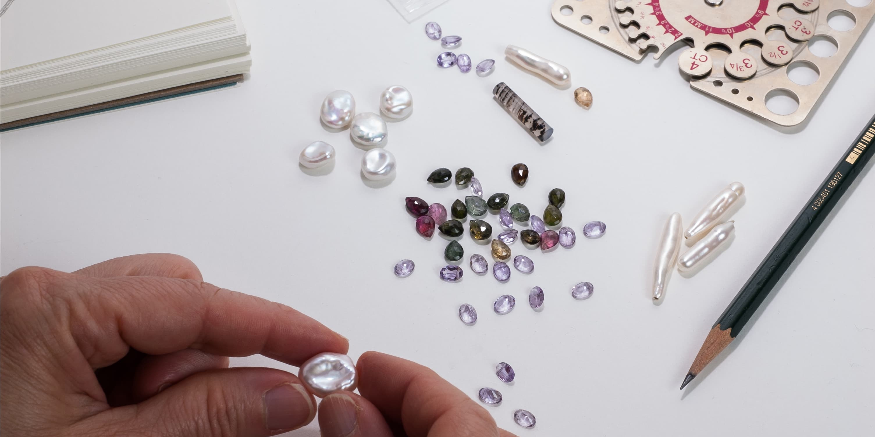 Ana sorting pearls and gemstones in her studio